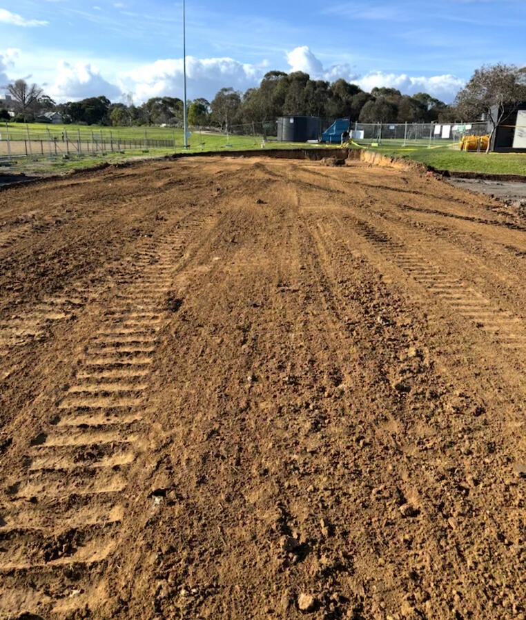 Large-scale site cut and land clearing completed in Melbourne, showing levelled soil ready for construction.