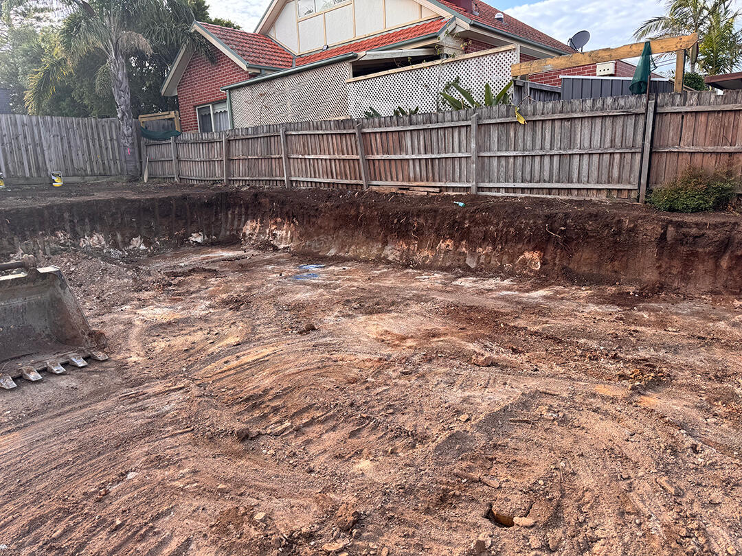 Ground being flattened and prepared by an excavator in Melbourne as part of professional site cut services.